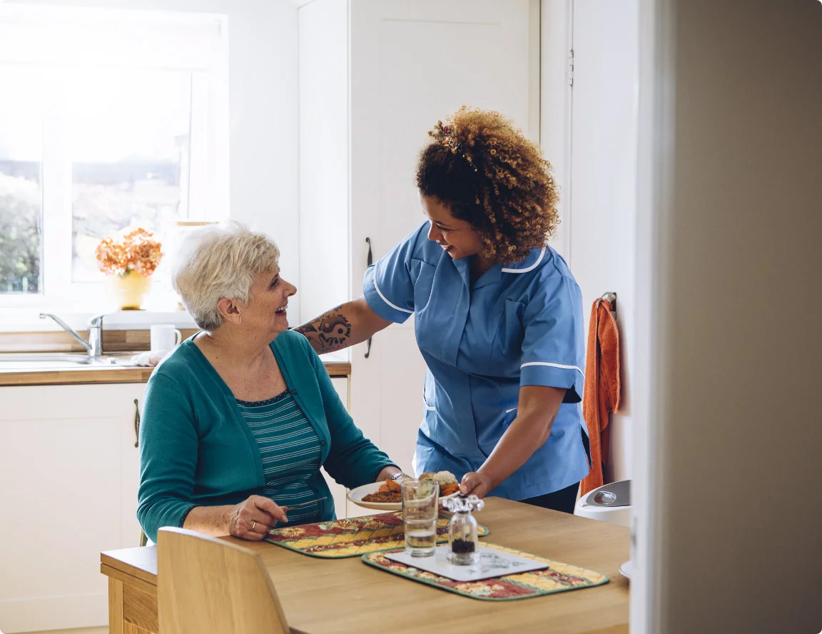 care-sector@2x Female care worker in a client's home.